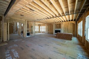Family seated in a clean living area beside a sealed renovation zone with floor coverings and storage bins